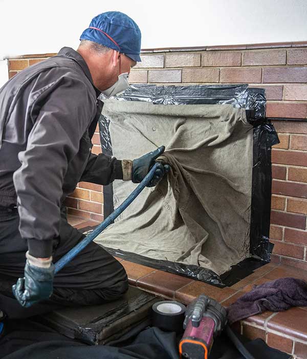 Technician Cleaning Chimney Technician Cleaning Chimney