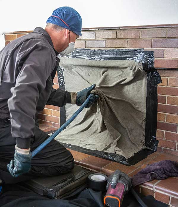 Technician Cleaning Chimney