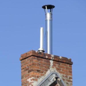metal chimney flue coming out of a brick or masonry chimney